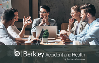Berkley Accident and Health Young business team sitting around conference table in a discussion