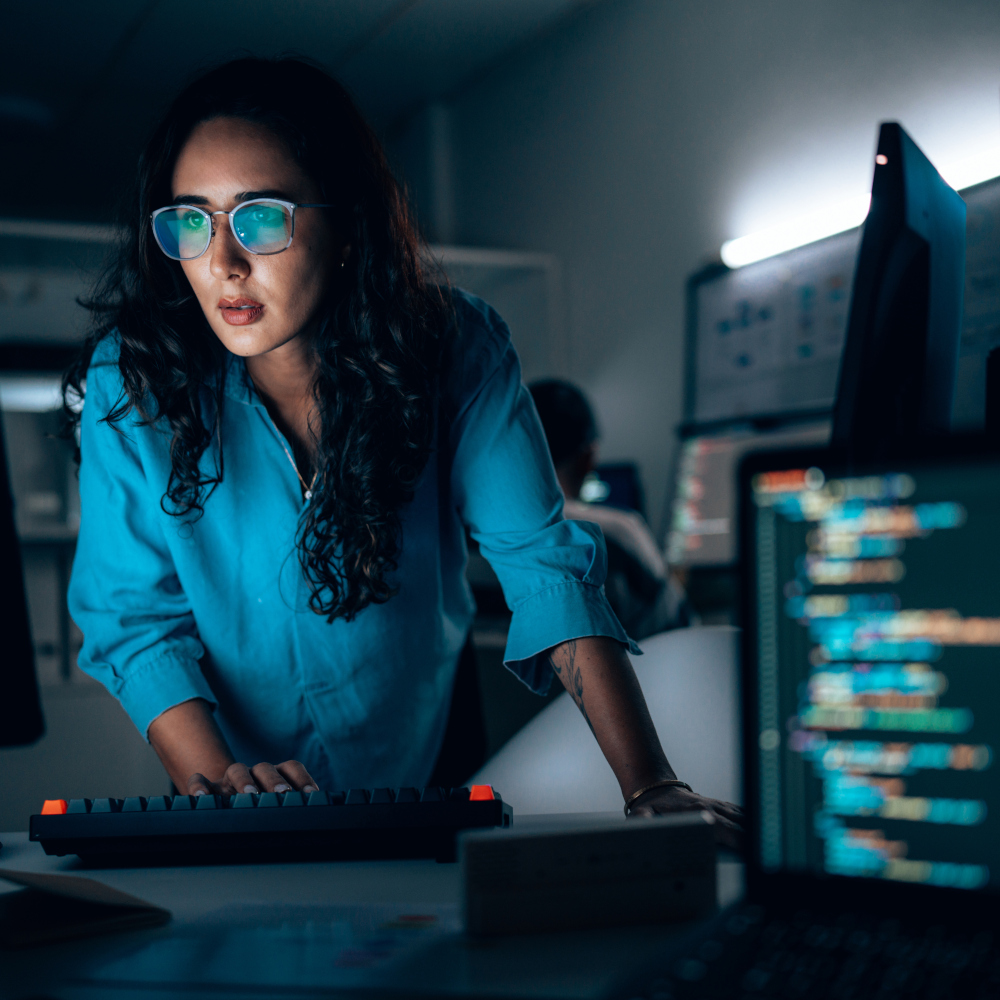 Women leans forward looking at monitor