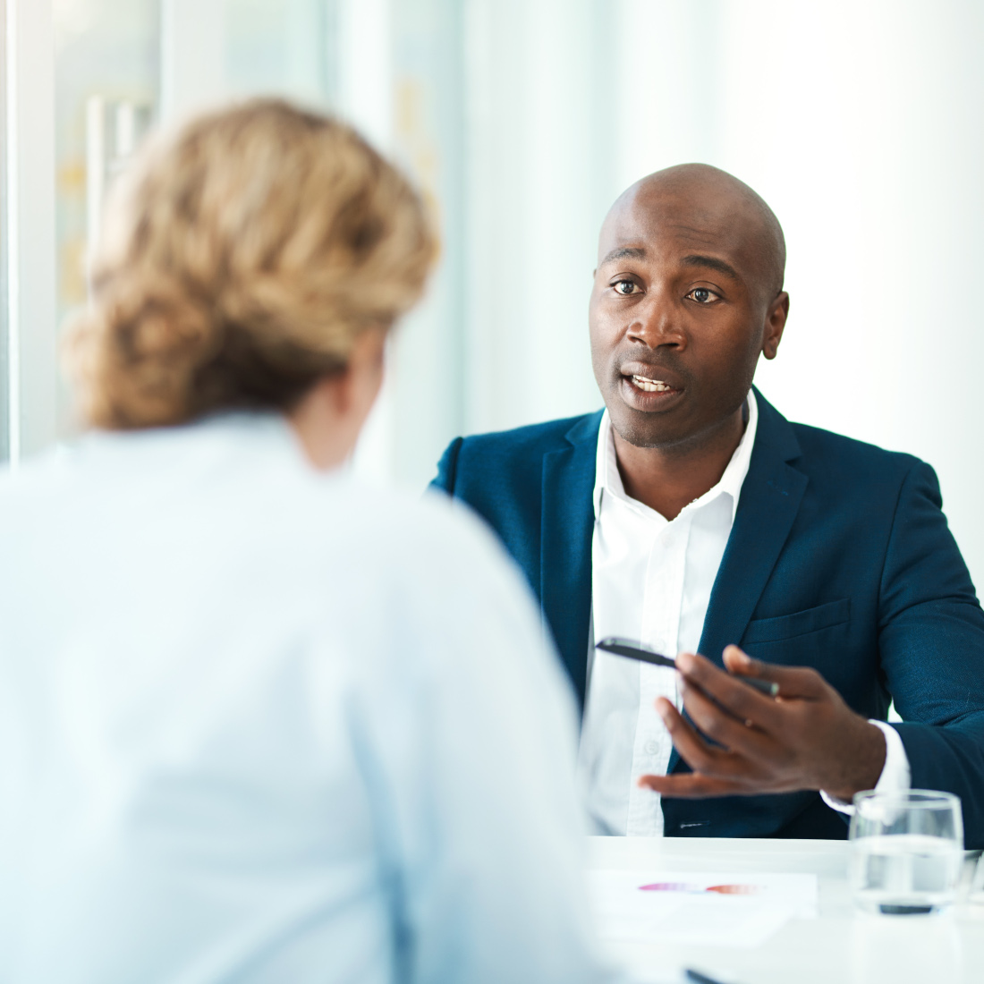 Man consults woman across the table