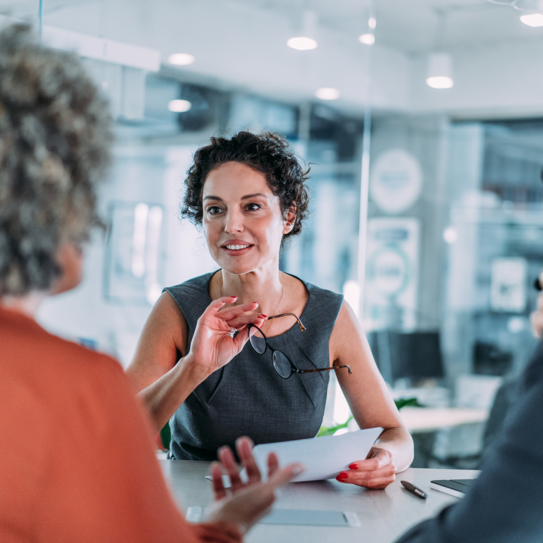 Women holds paper and glasses