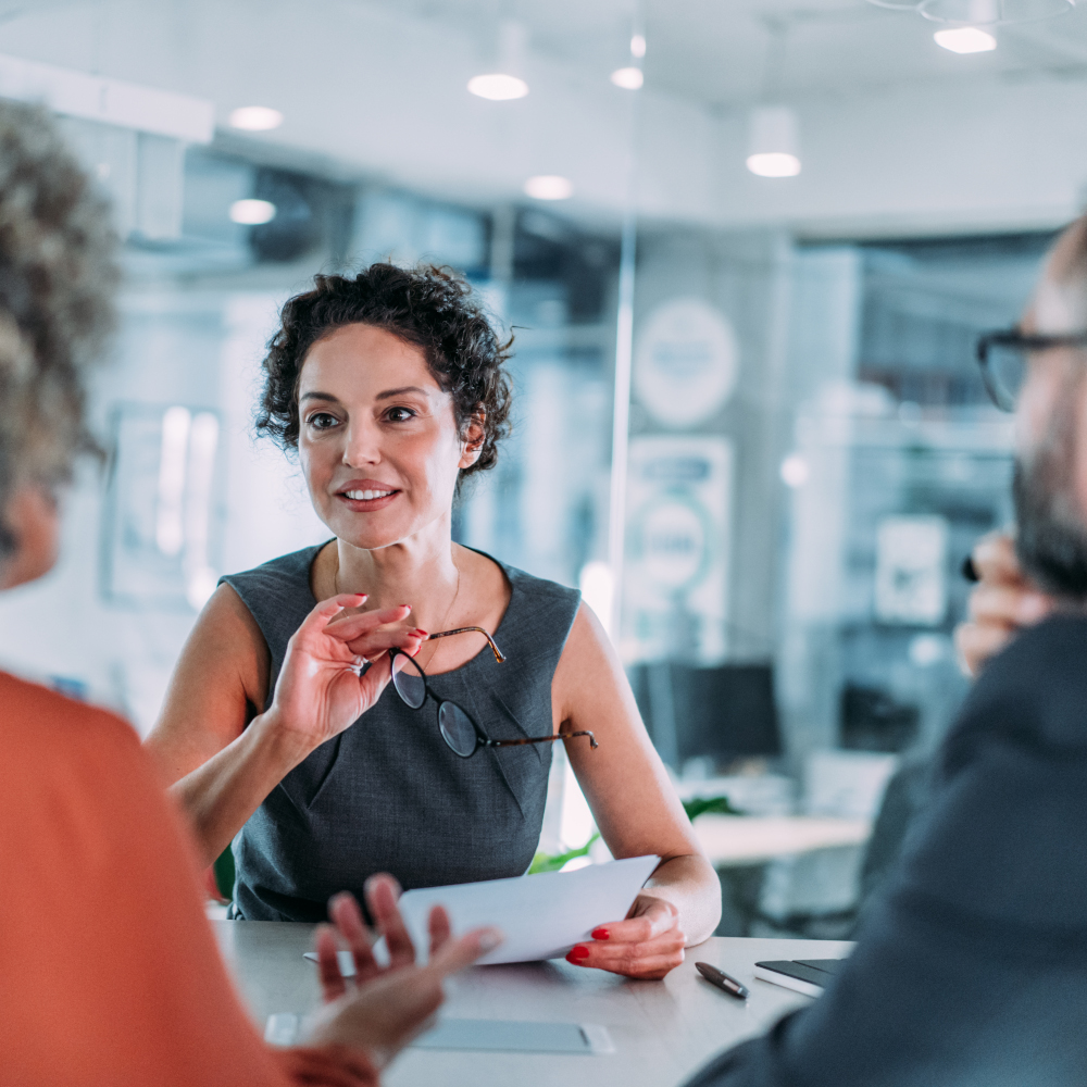 Woman holds paper and glasses