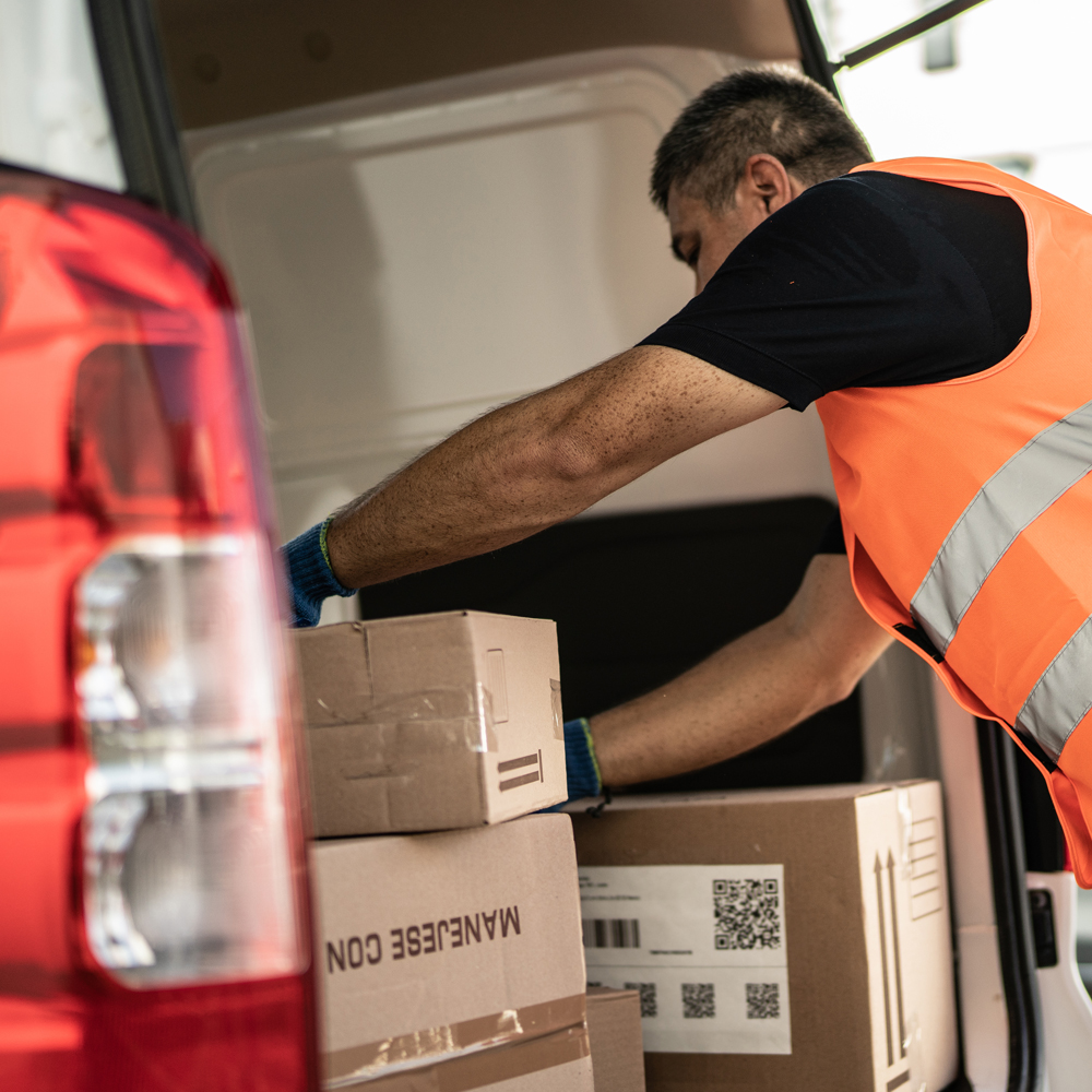 Worker packs boxes into van